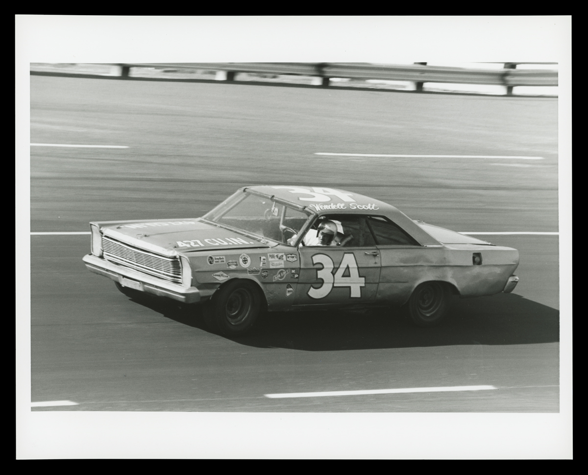 Car, with large number 34 on door, on racetrack