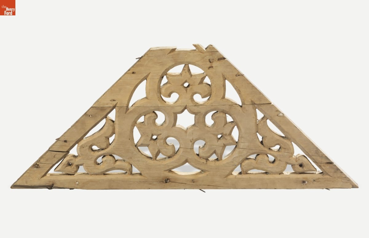 Unpainted triangular wooden bracket with scrollwork design