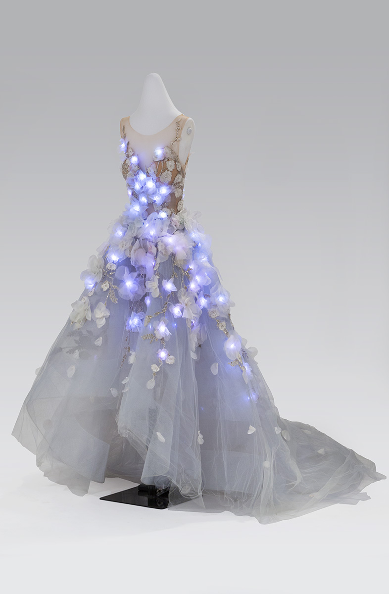 Dress on dress form with glowing blue lights integrated into bodice and skirt