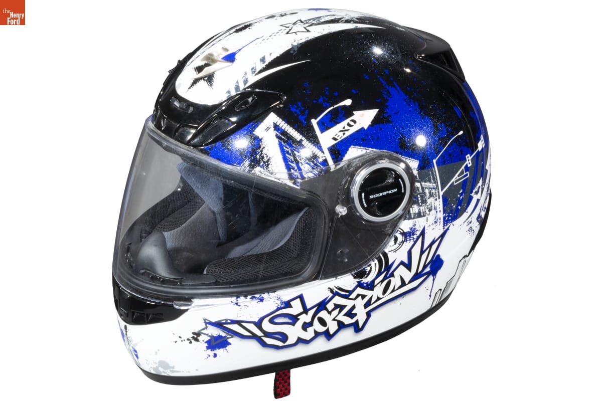 White, blue, and black helmet with "graffiti" style text and pattern