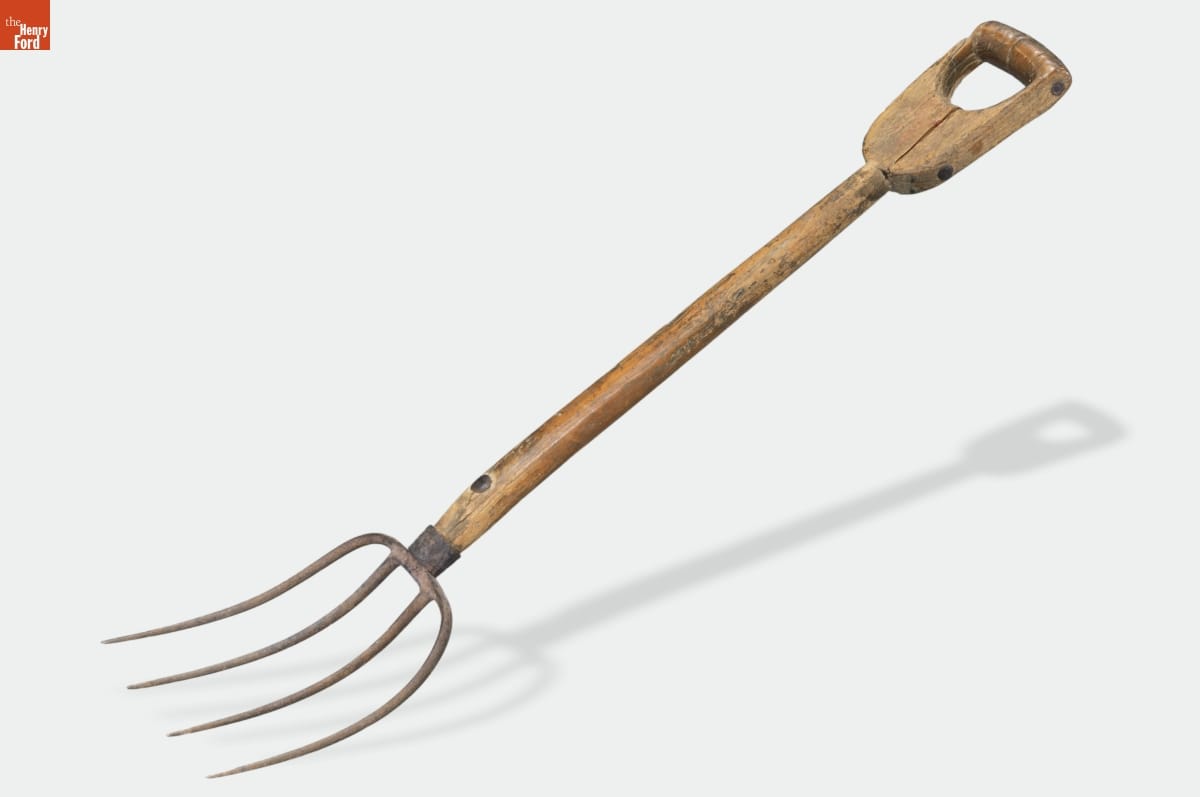 Wooden-handled pitchfork with four metal tines
