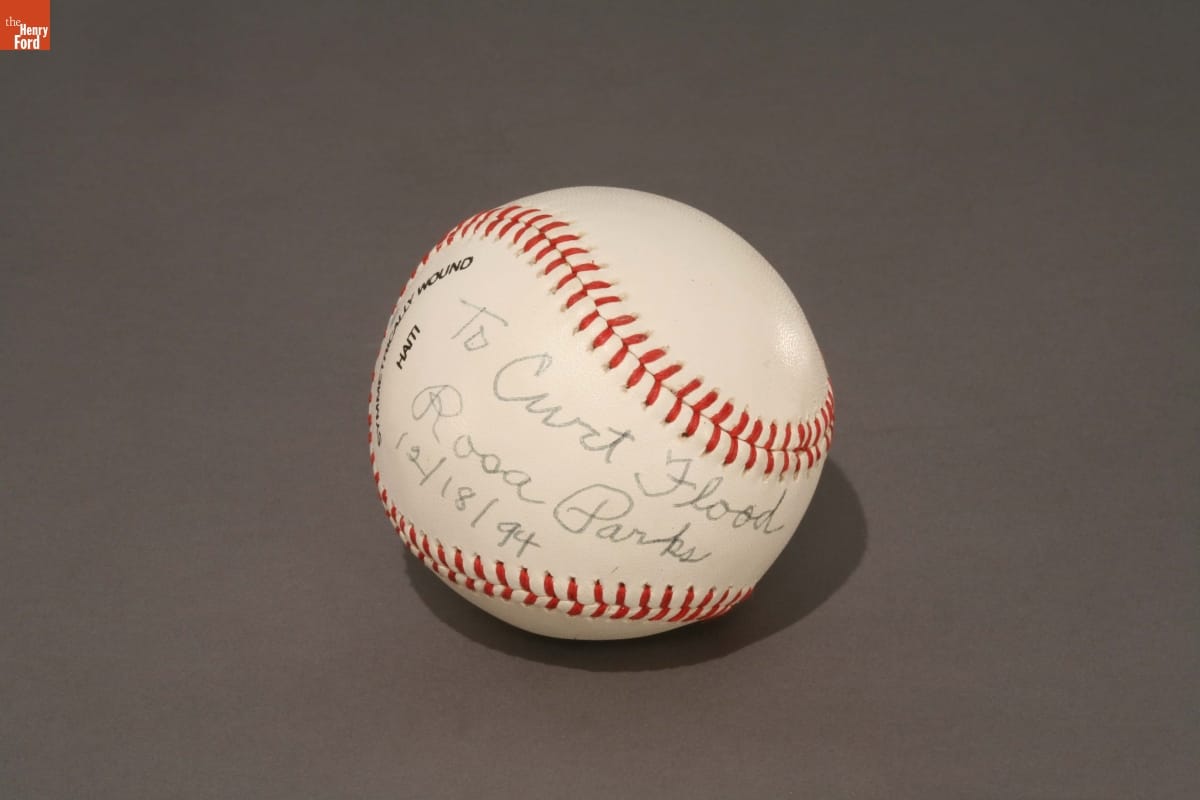 Autographed Baseball from Rosa Parks to Curt Flood, December 18, 1994 White baseball with red stitching and handwritten text