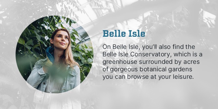 Belle Isle Conservatory Detroit, Michigan - On Belle Isle, you'll also find the Belle Isle Conservatory, which is a greenhouse surrounded by acres of gorgeous botanical gardens you can browse at your leisure. Photo of a person standing around greenery.