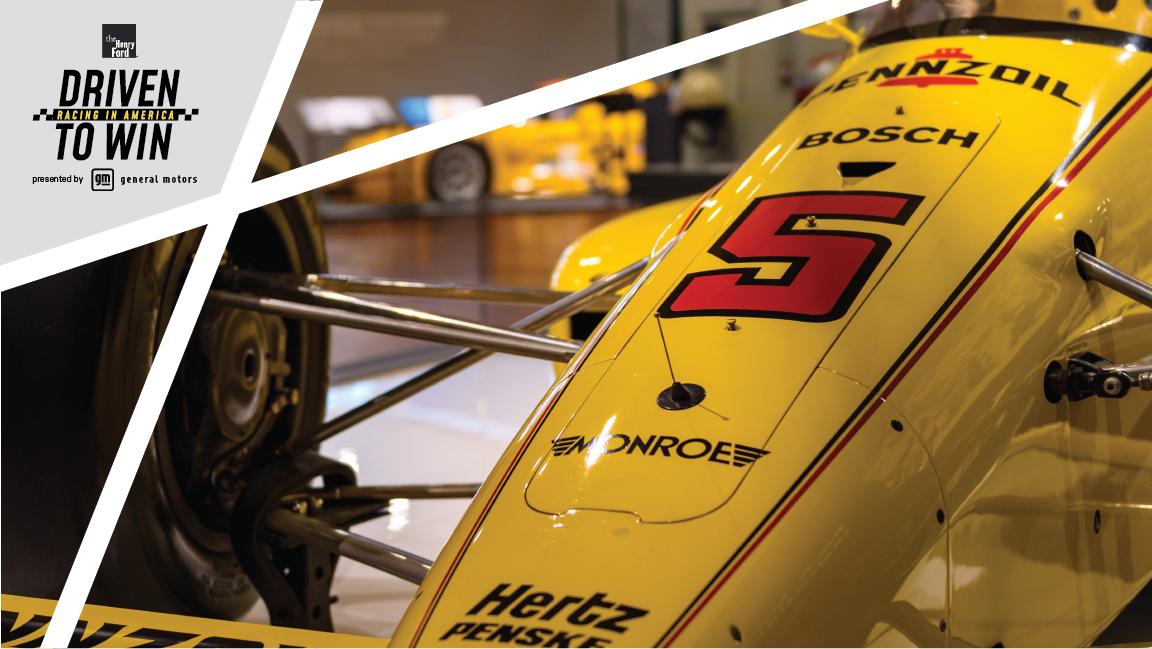 1988 Rick Mears Winning Indy Car Replica in Driven to Win Tight shot of hood and wheel of low yellow race car with number 5 and other text on hood