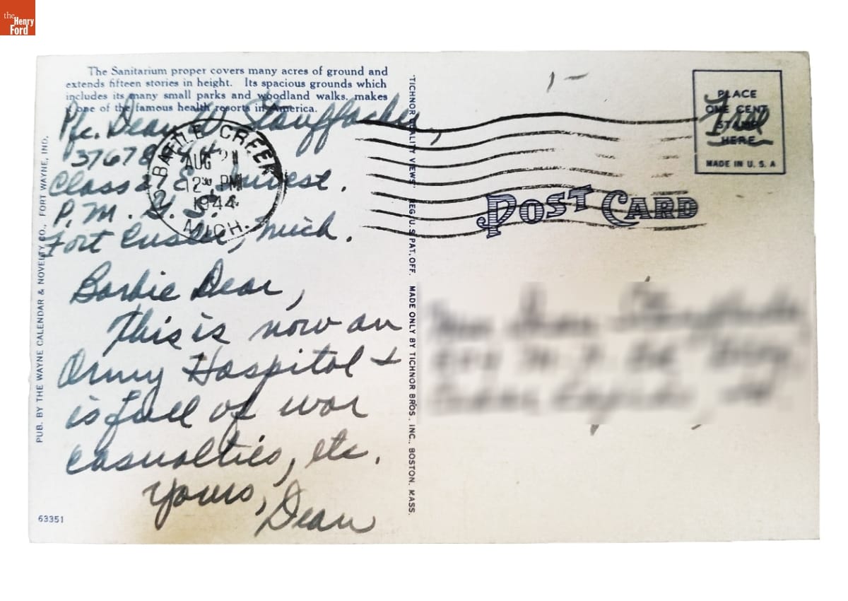 Postcard with printed text and handwritten note; blurred addressee