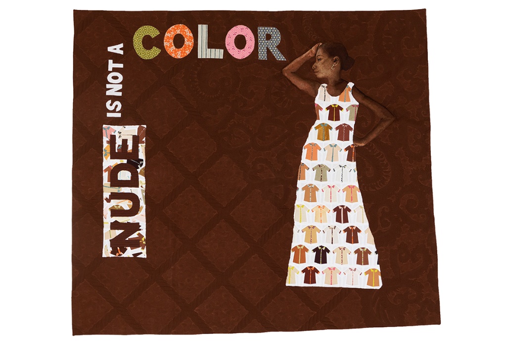 "Nude is Not a Color" Quilt, Made by Hillary Goodwin, Rachael Dorr, and Contributors from around the World, 2017 Brown quilt with quilted text "NUDE IS NOT A COLOR" and image of brown-skinned woman in pale dress covered with smaller images of shirts in many shades