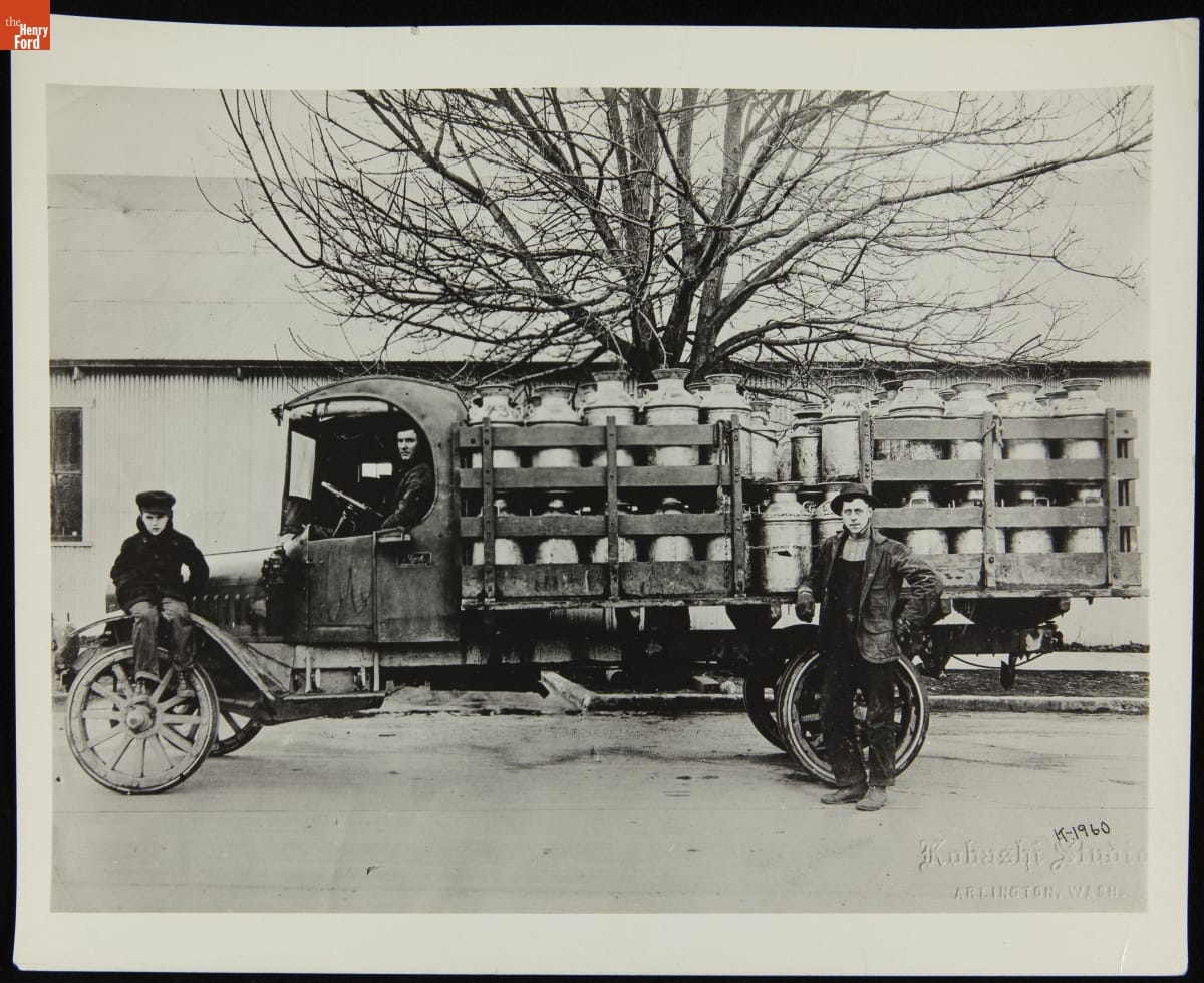 thf277311 Two Men and a Boy Pose with a Mack Model AB Stake Truck Loaded with Milk Cans, 1920