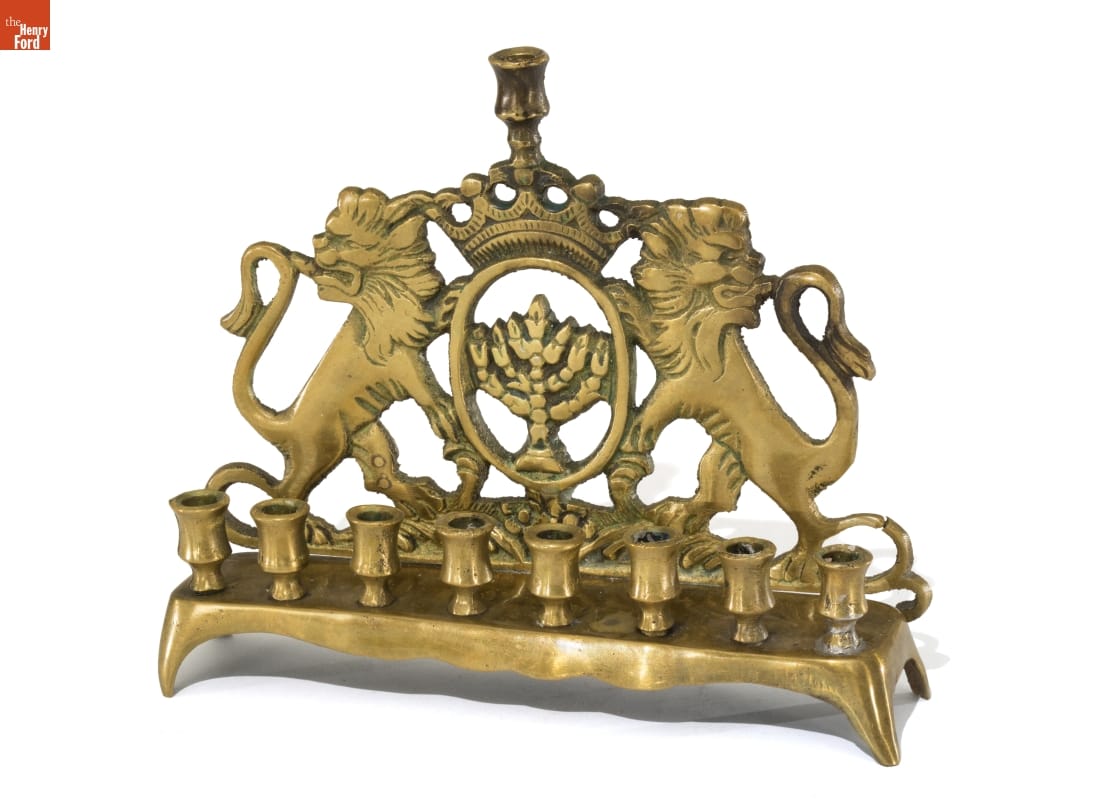 Brass candlestand with 9 spots for candles and backing with lions and a crown