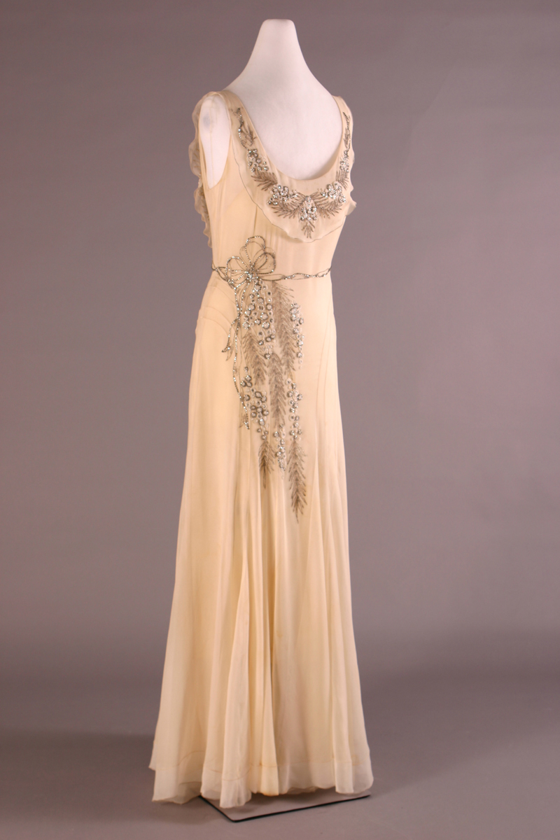 Beige or pale peach sleeveless dress with beaded detailing