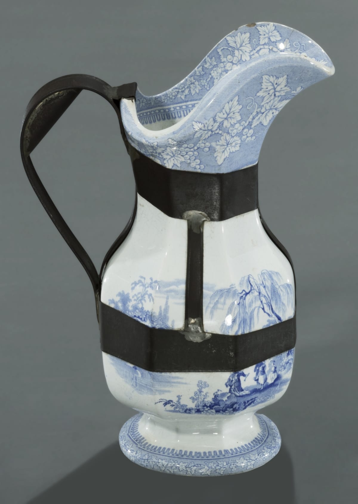 Pitcher, 1839-1846 Photograph of a ceramic pitcher that has been reinforced by a tinsmith with a metal structure