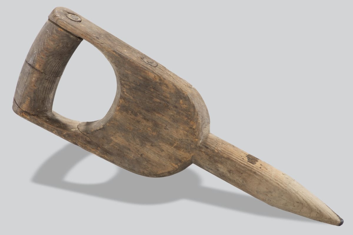 Wooden implement with broad handle and pointed end