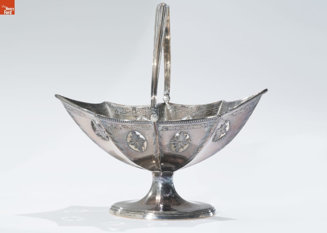 Silver dish with basket-like shape and handle