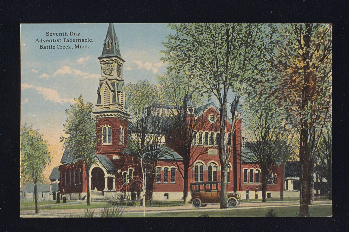 Postcard showing Seventh-day Adventist Tabernacle, 1914, a red brick building with a steeple and many arched windows.