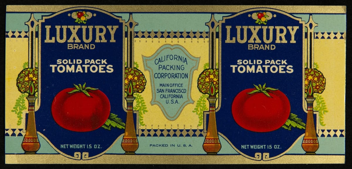 Cream, light blue, and dark blue can label with stylized flower arrangements in vases and two large images of tomatoes