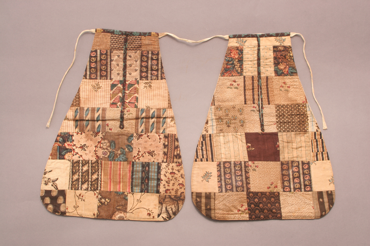 Two pear-shaped patchwork pockets connected by a cord or string