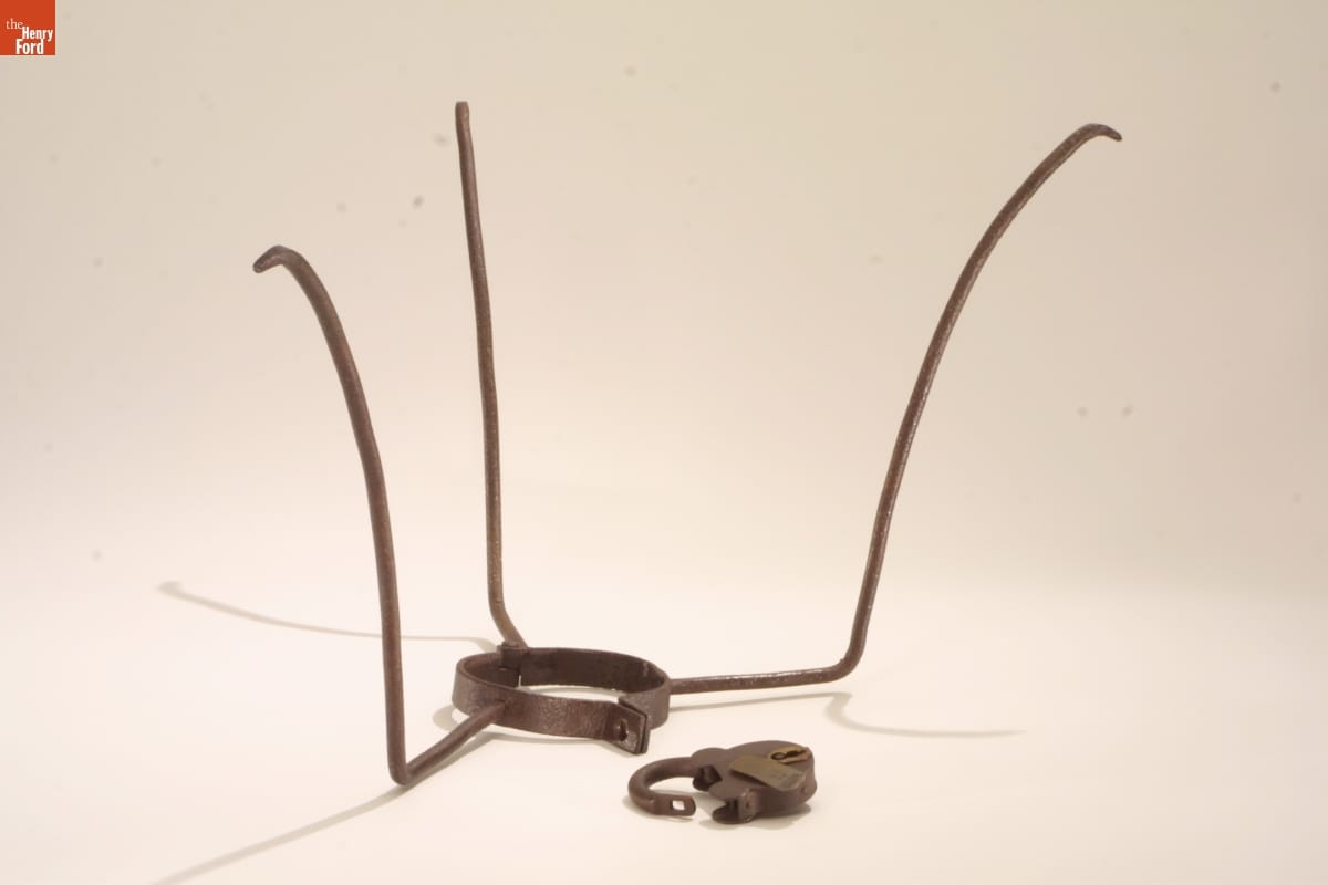 Collar with three tall prongs extending upward and heavy lock.