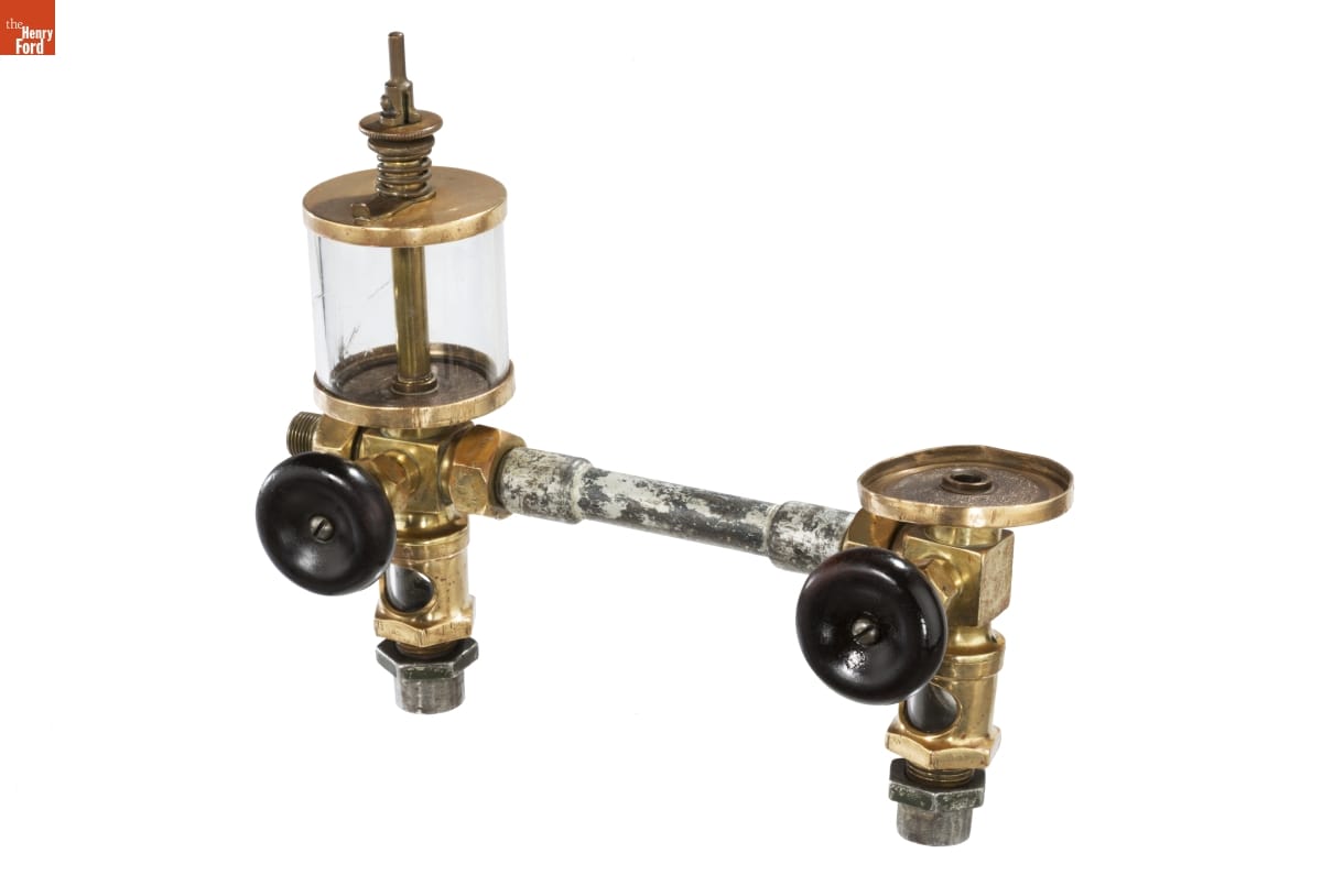 Piece of equipment with metal and brass fittings and black knobs