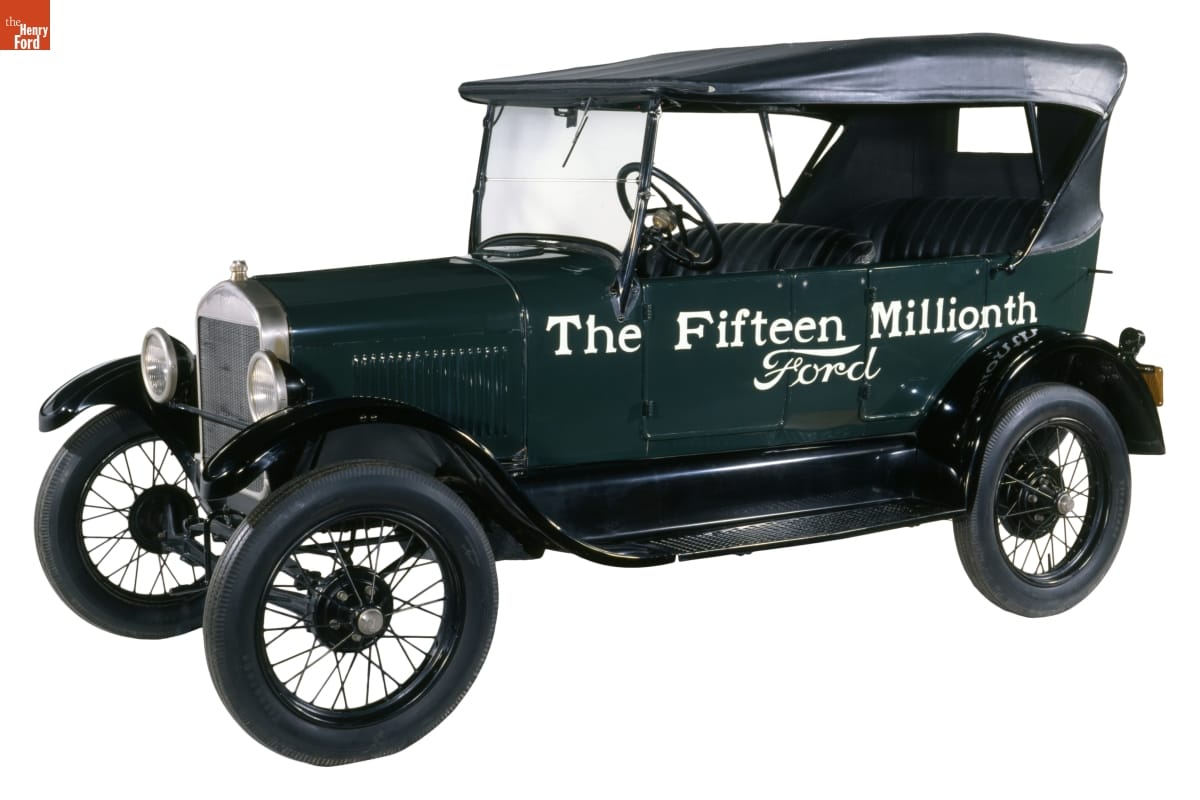 Green car with black top, with text on side: "The Fifteen Millionth Ford"