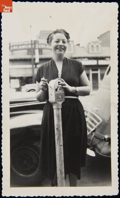 Woman with a Coin-Operated Parking Meter Woman with a Coin-Operated Parking Meter