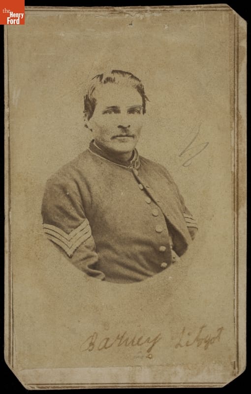 Matted, oval, black-and-white photograph of man in military uniform