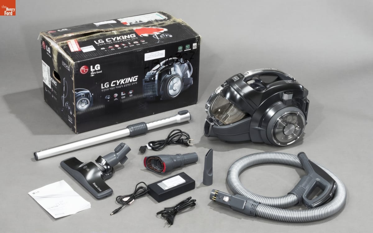 Compact wheeled vacuum pictured with a box and many accessories