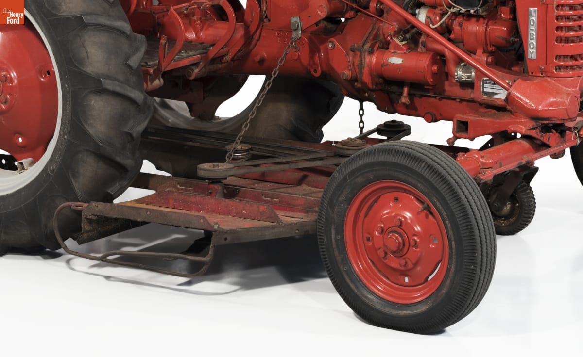 Close-up of red metal plate mounted beneath red tractor