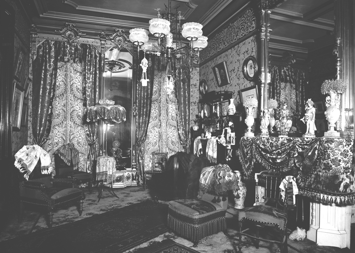 Room crowded with furnishings and drapery