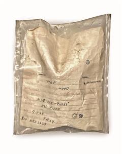 Bag with printed label filled in with handwritten text